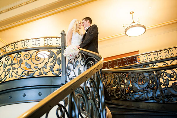 Grand stair case. bride and groom share a special glance